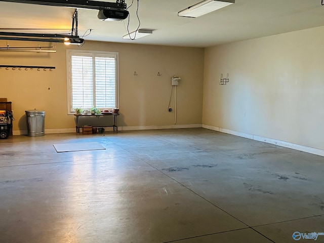 garage with a garage door opener and baseboards