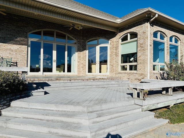 entrance to property featuring french doors and a wooden deck