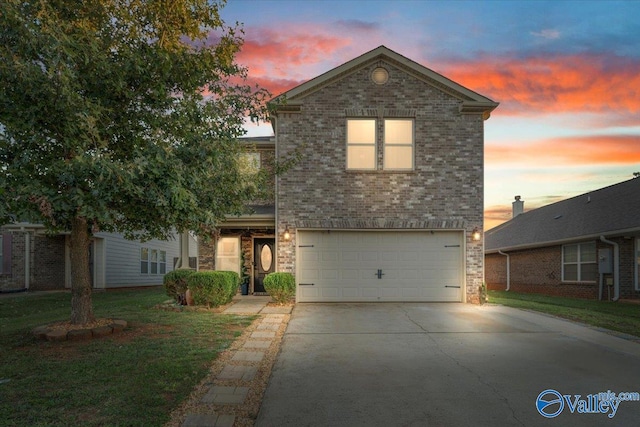 front facade with a yard and a garage