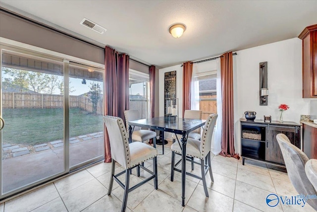 tiled dining area with a healthy amount of sunlight