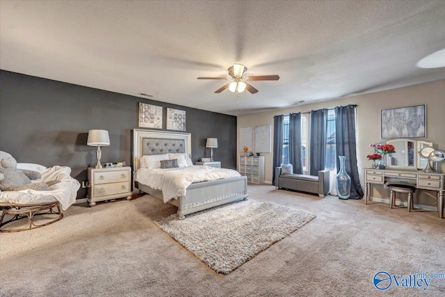 bedroom featuring light carpet, a textured ceiling, and ceiling fan