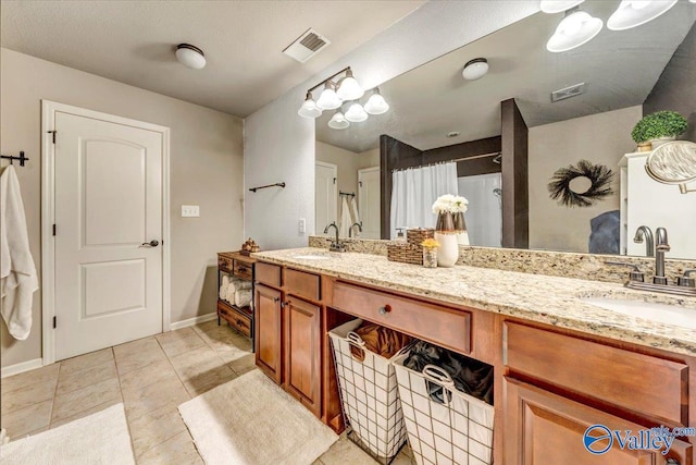 bathroom with vanity, curtained shower, and tile patterned floors