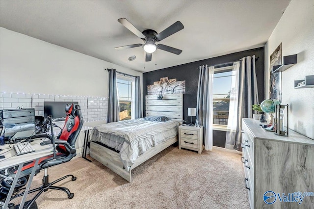 bedroom featuring light colored carpet and ceiling fan