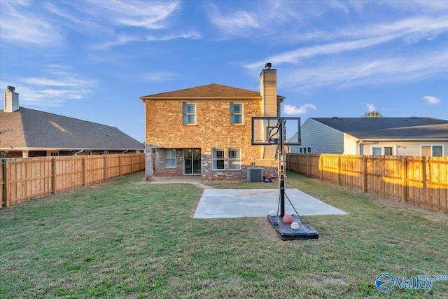 rear view of property featuring central air condition unit, a patio area, and a yard