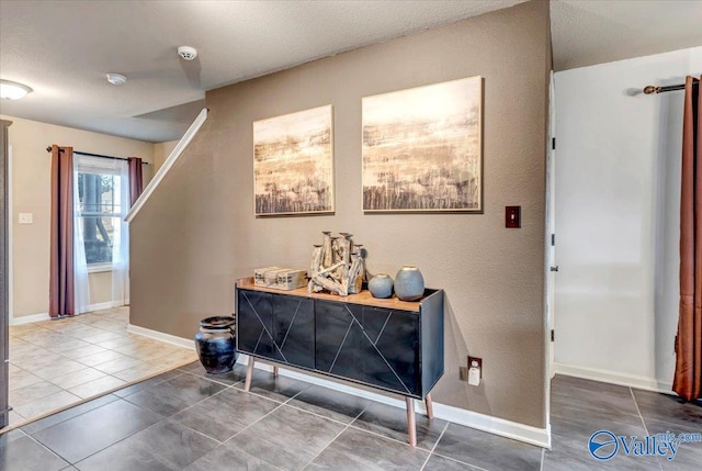 interior space featuring tile patterned floors and a textured ceiling