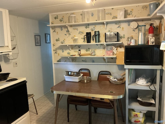 35 County Road 568, Leesburg, AL 35983 - kitchen with black microwave, electric stove, and tile patterned floors