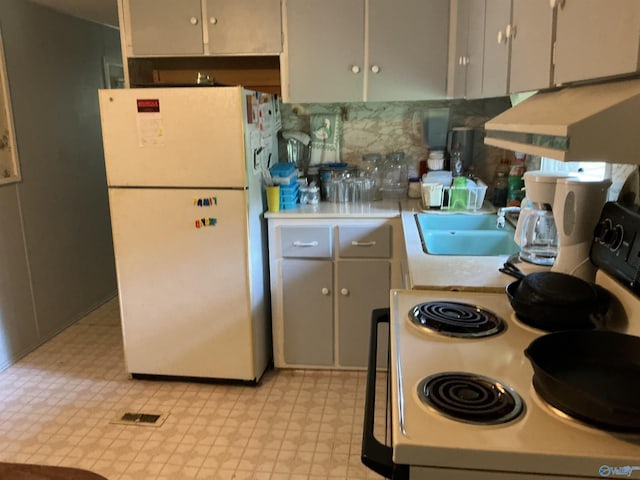 35 County Road 568, Leesburg, AL 35983 - kitchen featuring freestanding refrigerator, light flooring, light countertops, decorative backsplash, and gray cabinets