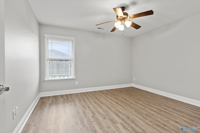 spare room with light hardwood / wood-style floors and ceiling fan