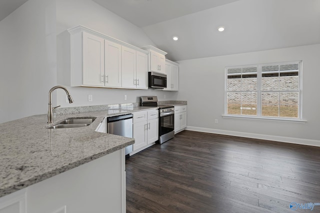 15354 Springbrook Trce, Athens, AL 35611 - kitchen with white cabinets, a sink, vaulted ceiling, stainless steel appliances, and light stone counters