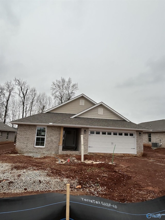 15354 Springbrook Trce, Athens, AL 35611 - view of front facade with an attached garage, a shingled roof, driveway, and brick siding