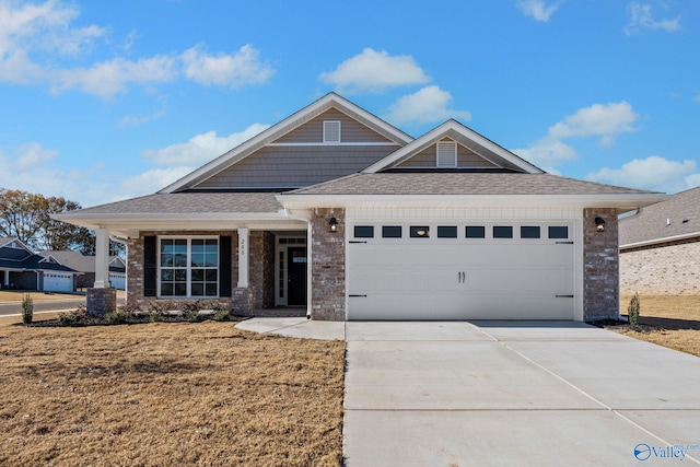15354 Springbrook Trce, Athens, AL 35611 - craftsman house featuring a garage, a front yard, brick siding, a shingled roof, and driveway