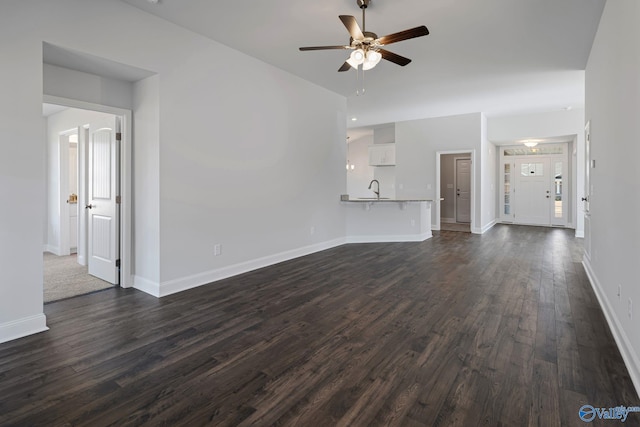 15354 Springbrook Trce, Athens, AL 35611 - unfurnished living room with ceiling fan, baseboards, a sink, and dark wood finished floors