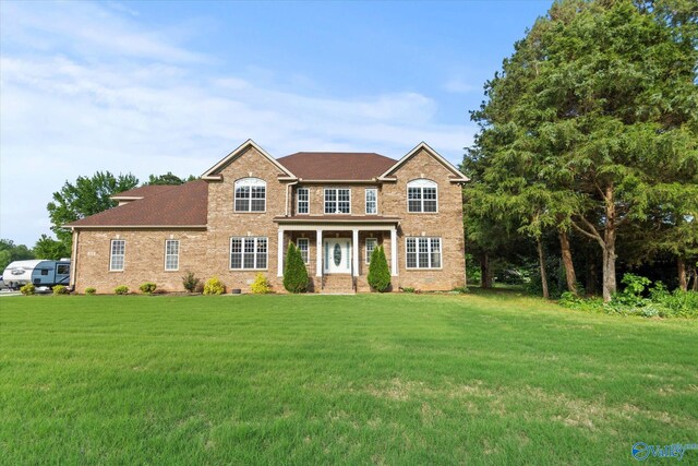 123 Coyote Creek Rd, Meridianville, AL 35759 - georgian-style home featuring a front lawn and brick siding