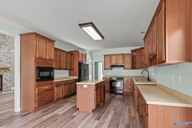 123 Coyote Creek Rd, Meridianville, AL 35759 - kitchen with black appliances, a sink, under cabinet range hood, crown molding, and light countertops