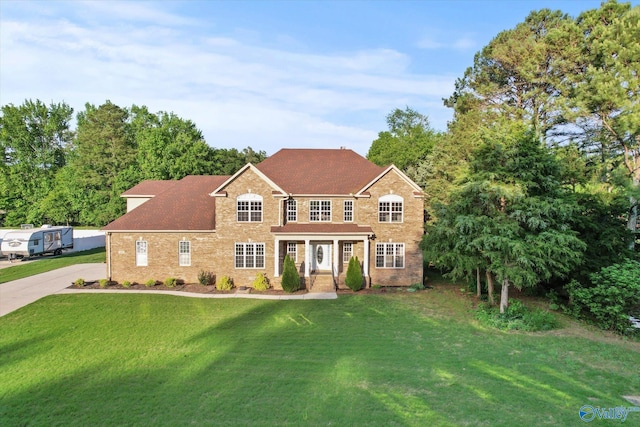 123 Coyote Creek Rd, Meridianville, AL 35759 - colonial house featuring a front yard, brick siding, and a shingled roof