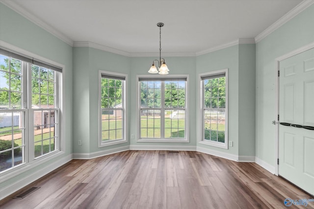 123 Coyote Creek Rd, Meridianville, AL 35759 - unfurnished dining area featuring a chandelier, wood finished floors, plenty of natural light, baseboards, and ornamental molding