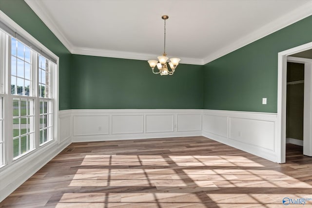 123 Coyote Creek Rd, Meridianville, AL 35759 - empty room with a chandelier, crown molding, wainscoting, and wood finished floors