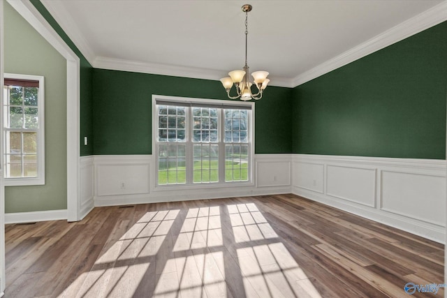 123 Coyote Creek Rd, Meridianville, AL 35759 - unfurnished dining area featuring a chandelier, wainscoting, crown molding, and wood finished floors