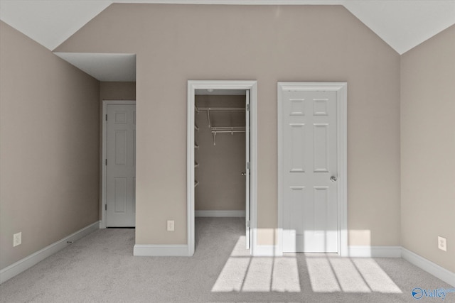 123 Coyote Creek Rd, Meridianville, AL 35759 - unfurnished bedroom with vaulted ceiling, carpet floors, a spacious closet, and baseboards