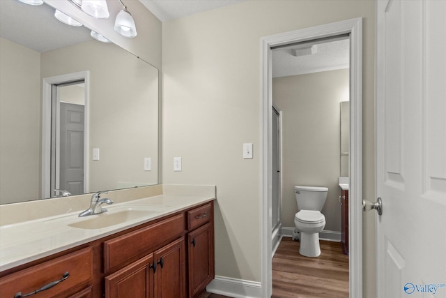 123 Coyote Creek Rd, Meridianville, AL 35759 - full bath with wood finished floors, toilet, vanity, baseboards, and a stall shower