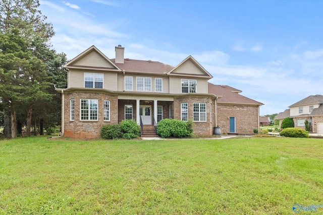 123 Coyote Creek Rd, Meridianville, AL 35759 - view of front of home featuring brick siding, a front lawn, and a chimney