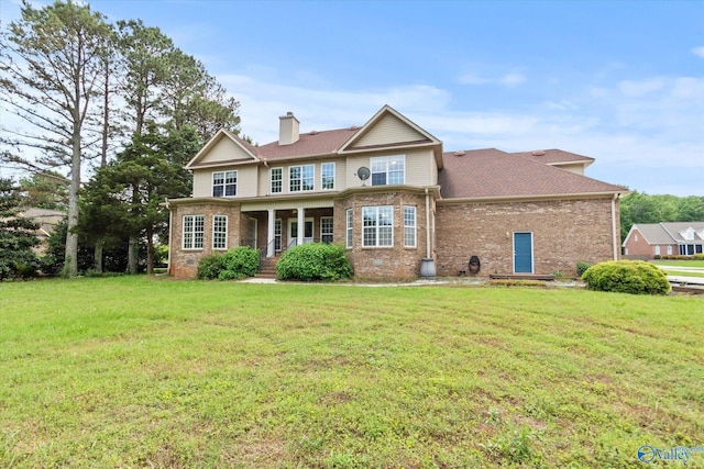 123 Coyote Creek Rd, Meridianville, AL 35759 - back of house with brick siding, a chimney, a yard, and a shingled roof