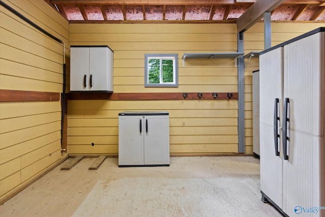 123 Coyote Creek Rd, Meridianville, AL 35759 - basement featuring wood walls and refrigerator