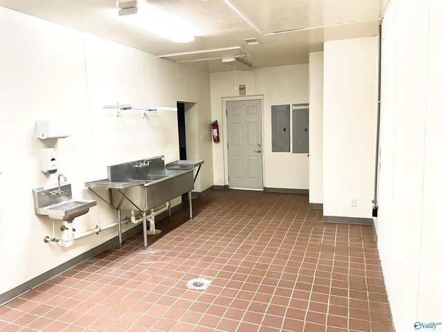 interior space featuring sink, tile patterned flooring, and electric panel