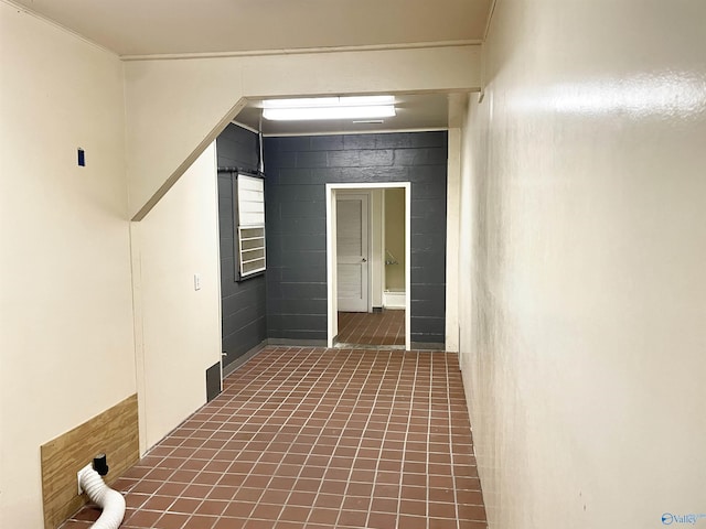 hallway featuring concrete block wall