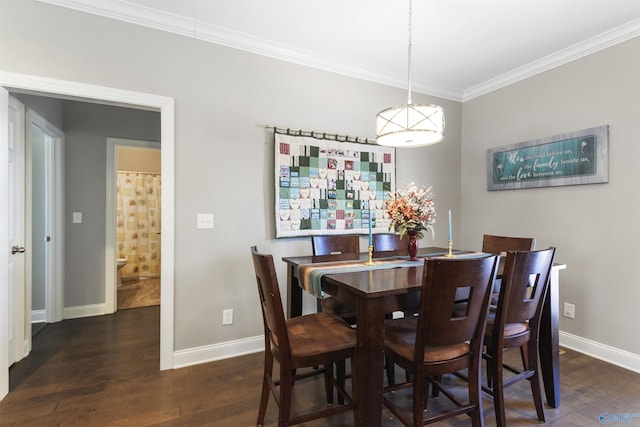 dining area with ornamental molding and dark wood-type flooring