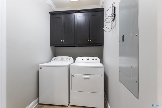 laundry area featuring ornamental molding, cabinets, and washing machine and dryer