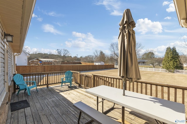 wooden deck with a lawn