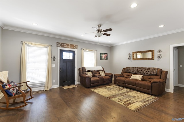 living room featuring dark wood-type flooring, a wealth of natural light, and crown molding