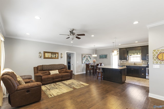 living room featuring ceiling fan, crown molding, and dark hardwood / wood-style floors