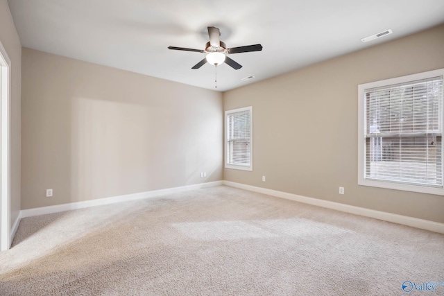 carpeted empty room featuring ceiling fan