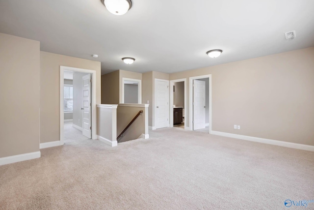 unfurnished room featuring light carpet