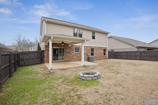 back of house with a lawn, ceiling fan, cooling unit, an outdoor fire pit, and a patio area