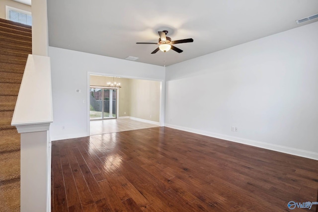 unfurnished living room with wood-type flooring and ceiling fan with notable chandelier