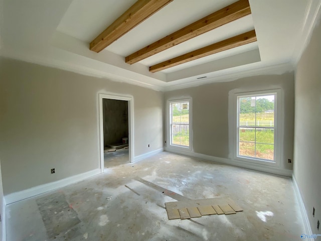 unfurnished room with beam ceiling