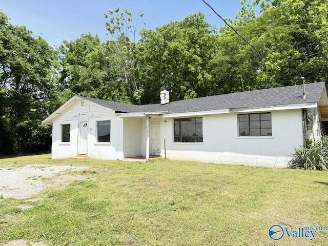 11801 W Gateway Dr SE, Huntsville, AL 35803 - view of front of property featuring a front lawn, a chimney, a shingled roof, and concrete block siding