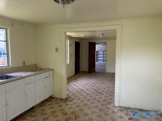 11801 W Gateway Dr SE, Huntsville, AL 35803 - kitchen with light floors, white cabinetry, light countertops, and a sink