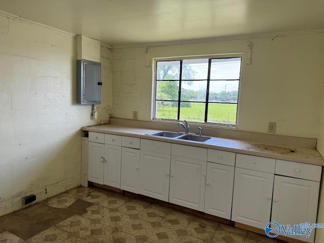 11801 W Gateway Dr SE, Huntsville, AL 35803 - kitchen with a sink, white cabinetry, electric panel, and light countertops
