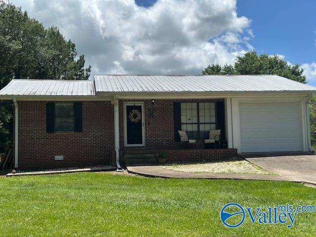 7015 Main St, Gadsden, AL 35903 - ranch-style house with an attached garage, a front yard, brick siding, a metal roof, and concrete driveway