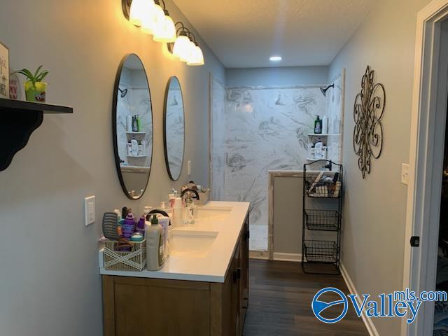 7015 Main St, Gadsden, AL 35903 - bathroom with double vanity, wood finished floors, and recessed lighting