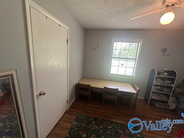 7015 Main St, Gadsden, AL 35903 - dining room with wood finished floors, a textured ceiling, and a ceiling fan
