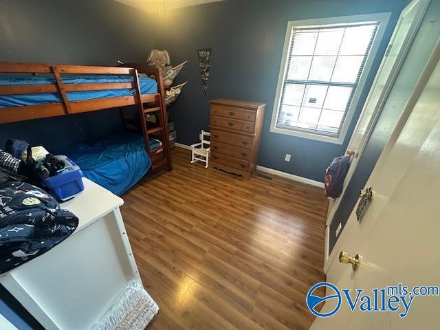 7015 Main St, Gadsden, AL 35903 - bedroom with wood finished floors and baseboards