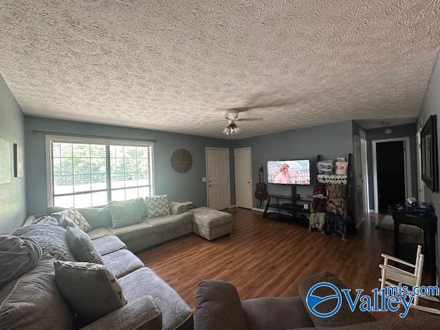 7015 Main St, Gadsden, AL 35903 - living area with a textured ceiling and wood finished floors