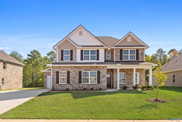 view of front of property featuring a front yard and a garage