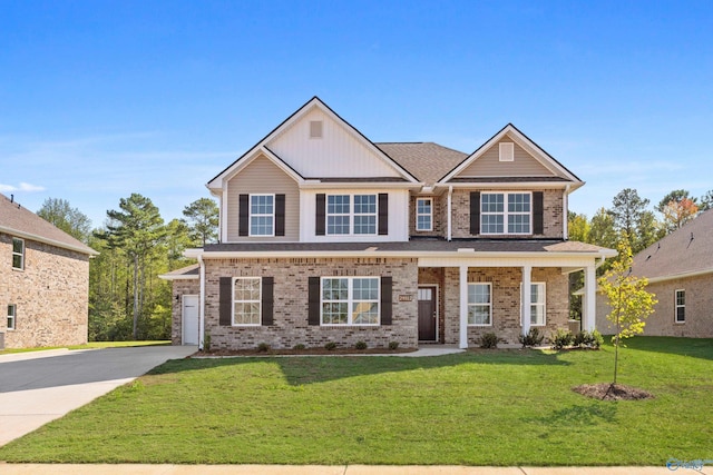 craftsman inspired home featuring a front yard and covered porch