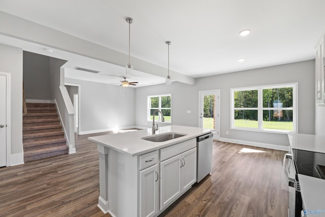 kitchen featuring a kitchen island with sink, sink, white cabinets, and appliances with stainless steel finishes